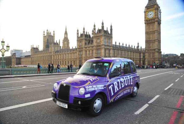 London Black Cab wrapped in eye catching purple, emblazoned with Tribute.